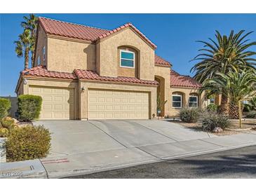 Charming two-story home with a three car garage, desert landscaping, and a red tile roof at 412 Lost Trail Dr, Henderson, NV 89014