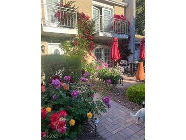 Charming patio with brick pavers, colorful flowers, and seating area at 738 Tam O Shanter, Las Vegas, NV 89109