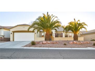 Single-story house with desert landscaping and two palm trees at 2771 Fort Myer Ave, Henderson, NV 89052
