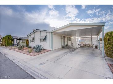 Single-wide manufactured home with carport and landscaped front yard at 3209 Tularosa Ln, Las Vegas, NV 89122