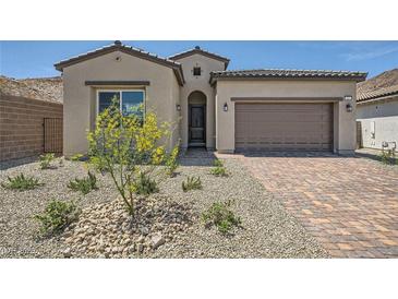 Charming one-story home with a desert landscape, brick driveway, and a two-car garage at 63 Ibiza Lake Dr, Henderson, NV 89011