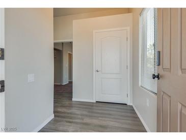Bright entryway with laminate flooring, neutral walls, and an interior door at 8805 Jeffreys St # 1115, Las Vegas, NV 89123