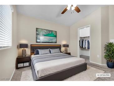 Bright bedroom featuring a walk-in closet, plush rug, and neutral decor at 9323 Leaping Deer Pl # 102, Las Vegas, NV 89178