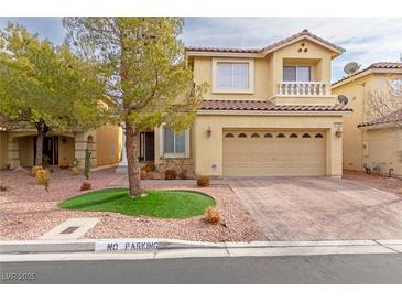 Two-story house with tan exterior, a large driveway, and landscaping at 10920 Fishers Island St, Las Vegas, NV 89141