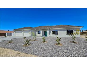 Charming single-story home with a three-car garage and drought tolerant landscaping at 2280 S Pampa Ave, Pahrump, NV 89048