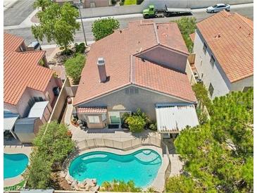 Aerial view of a private backyard featuring a sparkling pool and well-maintained landscaping at 3324 Canyon Lake Dr, Las Vegas, NV 89117