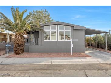 Gray single-wide manufactured home with carport and palm tree at 3580 Allegheny Dr, Las Vegas, NV 89122