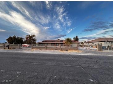 Single-story house with a large front yard and gated driveway at 3580 W Moberly Ave, Las Vegas, NV 89139