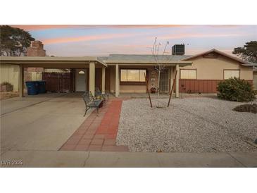 Ranch style home with carport, landscaped yard, and covered entryway at 3766 Millwood Ave, Las Vegas, NV 89121