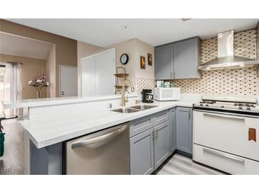 Updated kitchen features stainless steel appliances, modern cabinetry, and quartz countertops at 3800 Desert Marina Dr # 158, Laughlin, NV 89029