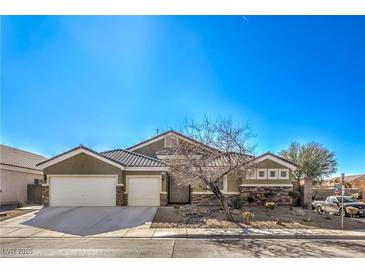 Single-story house with a two-car garage and desert landscaping at 5635 Exotic Rosette Ave, Las Vegas, NV 89139