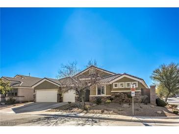 Charming single-story home featuring desert landscaping, three-car garage, and a tiled roof at 5635 Exotic Rosette Ave, Las Vegas, NV 89139