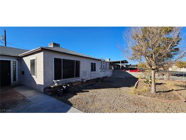 Ranch style home with gravel yard and mature tree at 612 Essex East Dr, Las Vegas, NV 89107