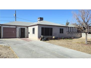 Charming single-story home with a front yard, driveway, and a one car garage at 612 Essex East Dr, Las Vegas, NV 89107