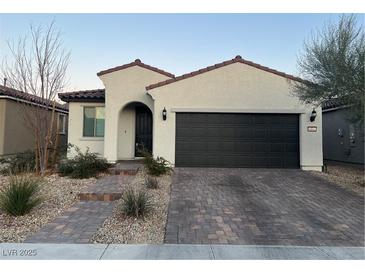 One-story home with a dark gray garage door and a landscaped front yard at 6842 Laguna Blanca St, North Las Vegas, NV 89086