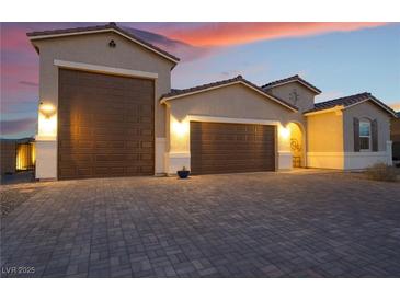 Beautiful two-story home with a three-car garage and landscaped front yard at 8750 Lutts St, Las Vegas, NV 89131