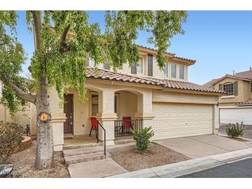 Two-story house with attached garage and landscaping at 947 Cantabria Heights Ave, Las Vegas, NV 89183