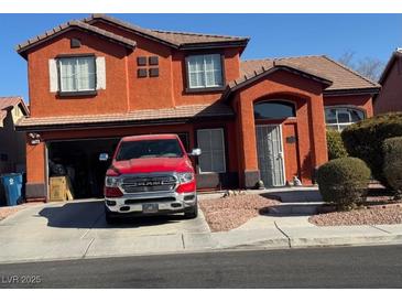 Two-story house with a red exterior and a red truck parked in the driveway at 1754 Green Apple Way, Las Vegas, NV 89142