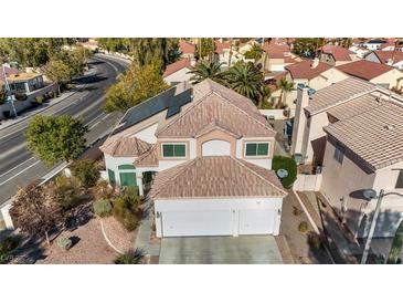 Two-story house with solar panels and a three-car garage, aerial view at 1812 Dalton Dr, Henderson, NV 89014