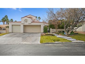 Two-story house with attached two-car garage and landscaped front yard at 2107 Inverness Dr, Henderson, NV 89074