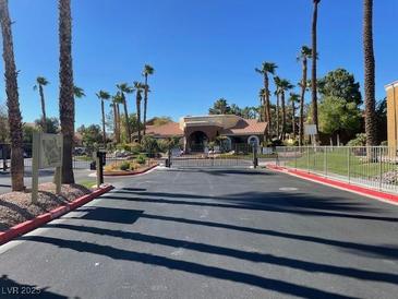 Gated community entrance with palm trees and security features at 2120 Ramrod Ave # 1721, Henderson, NV 89014