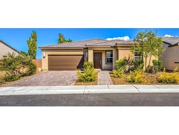 One-story home with brown garage door and landscaped front yard at 4390 E Cactus Canyon Dr, Pahrump, NV 89061