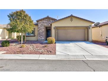 Single-story house with a two-car garage and desert landscaping at 4435 Lavender Ln, Pahrump, NV 89061