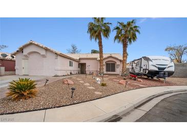 Single-story home with desert landscaping and RV parking at 4527 Buddy Holly Ct, North Las Vegas, NV 89031