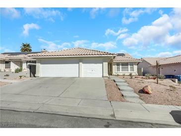 Single-story home with two-car garage and landscaped front yard at 4722 Casa Bonita Dr, North Las Vegas, NV 89032