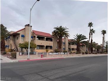 Attractive exterior of a two-story building with Spanish-style architecture and palm trees at 4750 Obannon Dr # D, Las Vegas, NV 89102