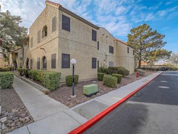 Tan stucco building exterior with walkway and landscaping at 4750 Obannon Dr # D, Las Vegas, NV 89102