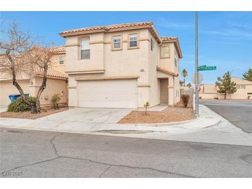 Two-story house with attached garage, landscaping, and a corner lot at 7732 Prosperity River Ave, Las Vegas, NV 89129