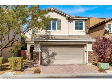 Two-story house with a two-car garage and landscaped front yard at 8960 Fox Season Ave, Las Vegas, NV 89178