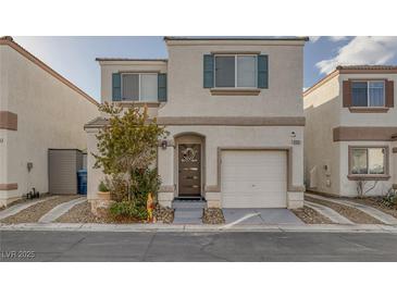 Two-story house with attached garage and landscaping at 10009 Delicate Dew St, Las Vegas, NV 89183