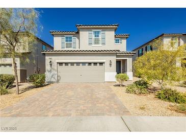 Two-story home with gray siding, gray shutters, and a paved driveway at 1004 Huckburn Ave, Henderson, NV 89015