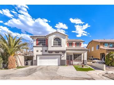 Two-story house with white exterior, red accents, and a two-car garage at 1144 Sage Valley Ct, Las Vegas, NV 89110