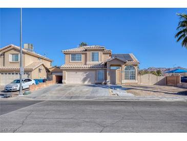 Two-story house with solar panels and a two-car garage at 2000 Golden Shadow Ct, Henderson, NV 89002