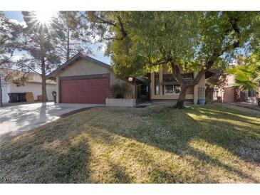 Single story house with attached garage and grassy front yard at 2353 Moorpark Way, Henderson, NV 89014