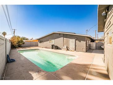 A backyard pool offers a refreshing escape with a concrete patio, perfect for relaxation and outdoor enjoyment at 2540 Eagle St, Las Vegas, NV 89142