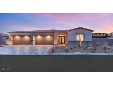 Stunning modern home with three-car garage and landscaped front yard at 2669 Pioneer Estates Ct, Las Vegas, NV 89117