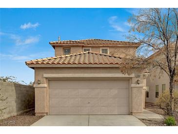 Two-story house with beige siding, attached garage, and a well-maintained front yard at 3968 Moon Tango St, Las Vegas, NV 89129