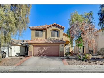 Two-story house with brown garage door and landscaped yard at 422 Waterbrook Dr, Henderson, NV 89015