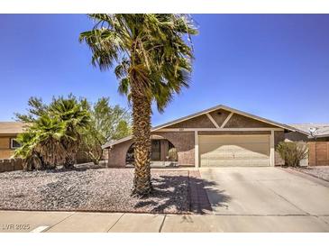 Single story home with a two-car garage and desert landscaping at 427 Shamrock Dr, Henderson, NV 89002