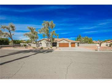 Single-story home with attached garage and desert landscaping at 5840 N El Capitan Way, Las Vegas, NV 89149