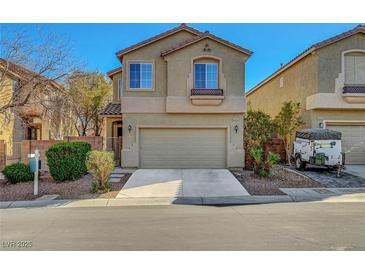 Charming two-story home featuring a neutral stucco facade, well-kept landscaping, and an attached two-car garage at 8040 Marshall Canyon Dr, Las Vegas, NV 89166