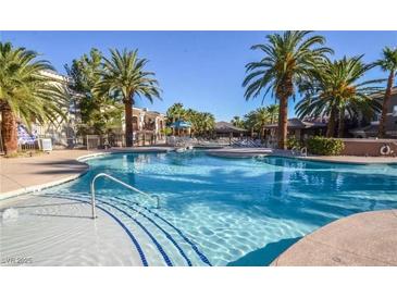 Inviting community pool with palm trees and ample space for relaxation at 9050 W Warm Springs Rd # 1137, Las Vegas, NV 89148