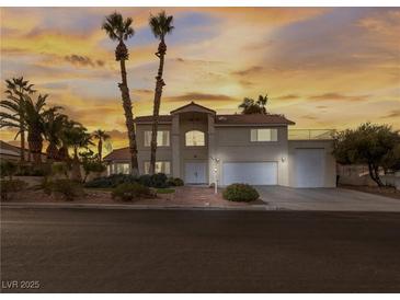 Two-story house with a three-car garage and mature landscaping at 908 Primrose Ln, Henderson, NV 89011