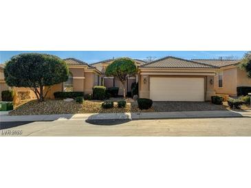 Single-story home with two-car garage, landscaping, and desert landscaping at 10505 Novella Ct, Las Vegas, NV 89135