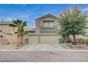 Two-story house with a three-car garage and landscaped front yard at 1125 Neva Ranch Ave, North Las Vegas, NV 89081