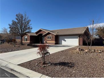 One-story home with attached garage and desert landscaping at 210 Bristle Cone, Pahrump, NV 89048